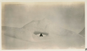 Image of Borup looking out of a hole in under glacier